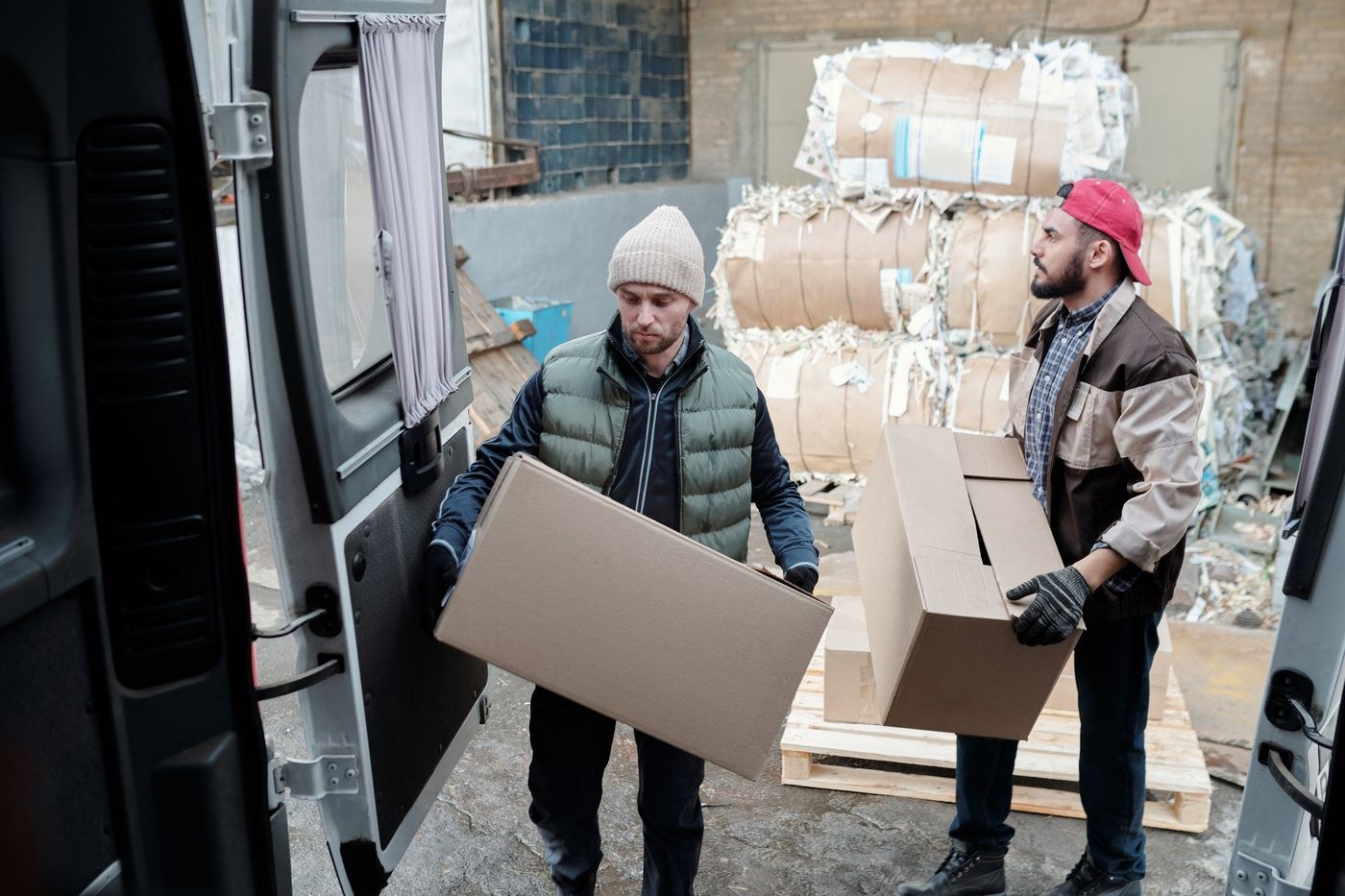 Workers lifting and carrying boxes