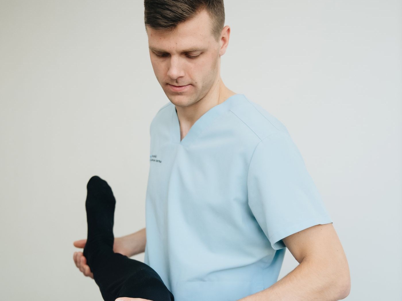 A therapist checking a patient’s joint range of motion (staged photo)